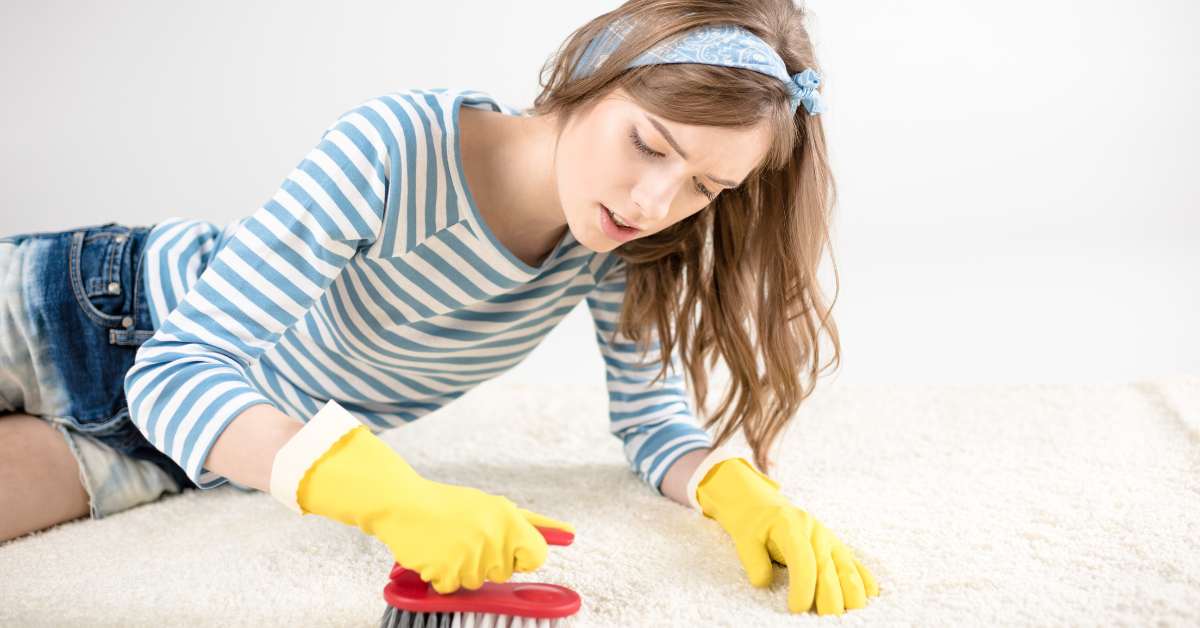 a woman cleaning old stains off carpet